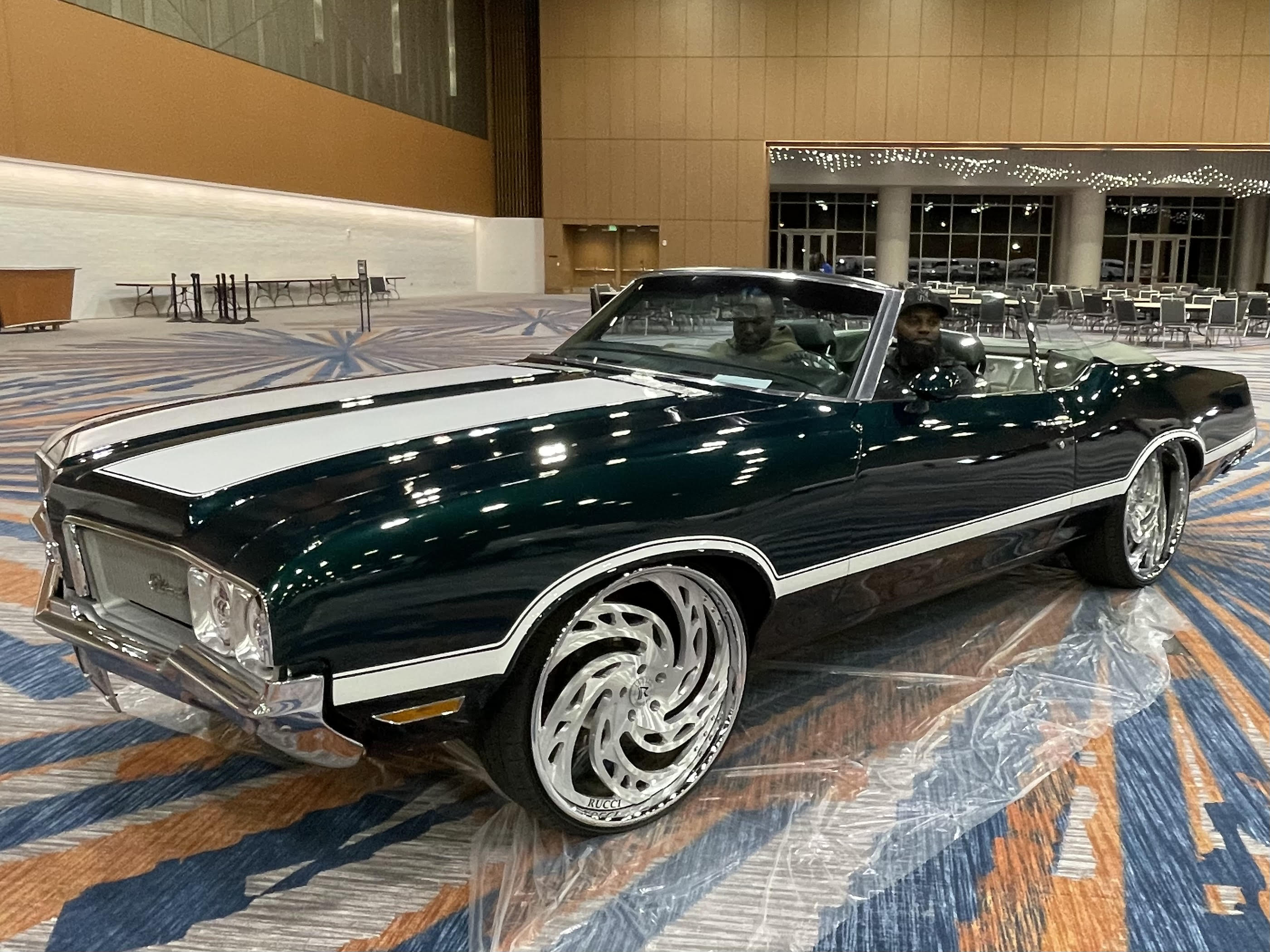 Dark green classic convertible featured inside the expo hall
