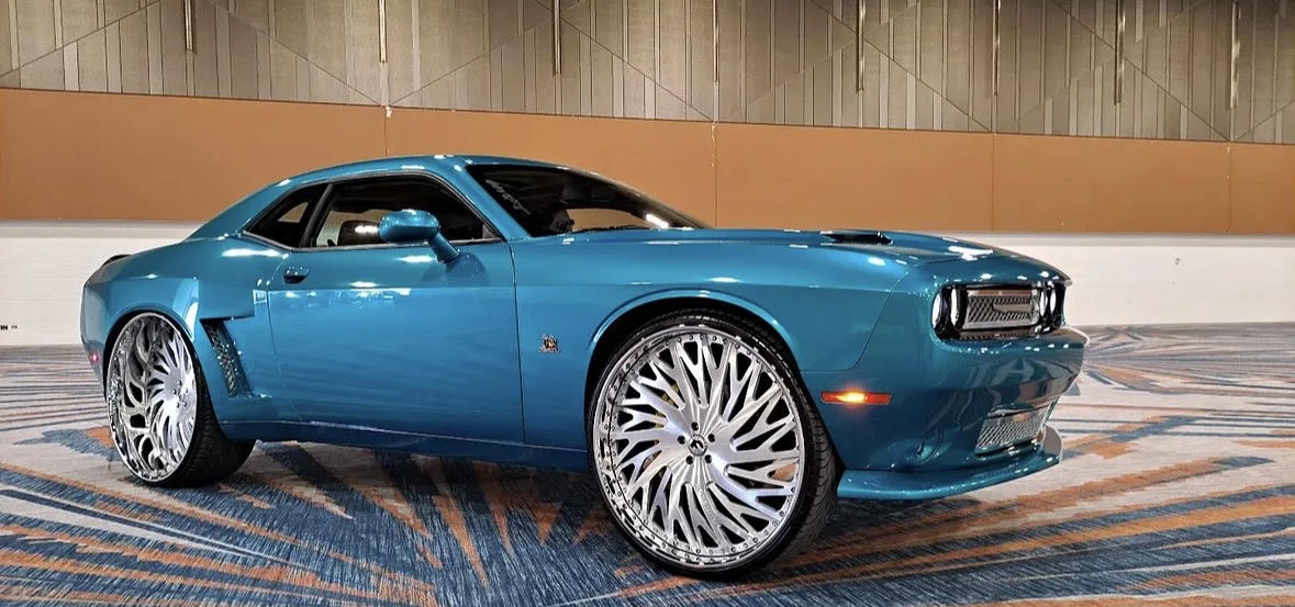Blue Dodge Challenger with oversized chrome wheels